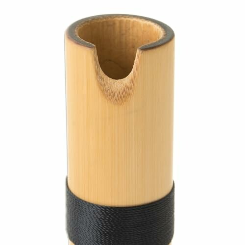 Close-up of a bamboo flute mouthpiece with black binding.