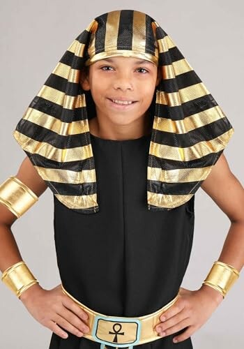 Child wearing an Egyptian pharaoh costume with gold and black headdress.