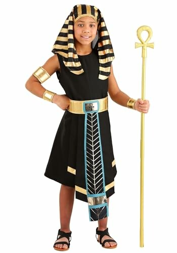 Child in Egyptian pharaoh costume holding a staff.