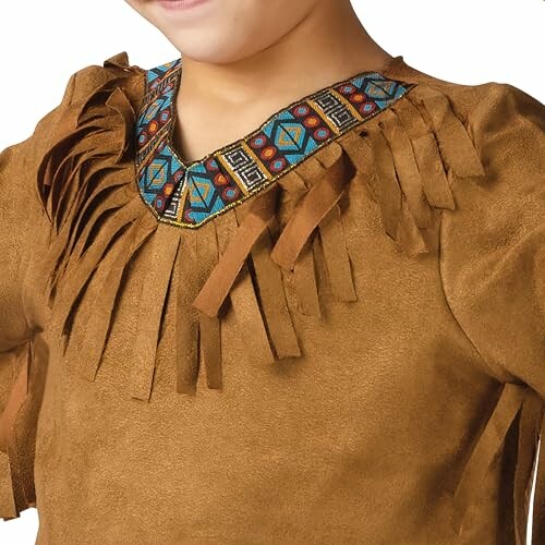 A child wearing a brown fringe shirt with colorful trim