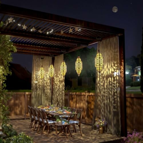 Elegant outdoor dining area at night with hanging lanterns and a pergola.